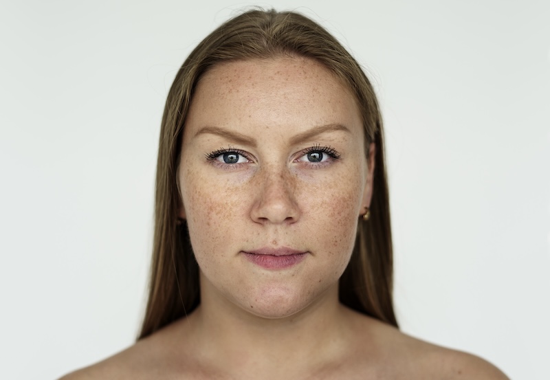 woman with long hair and freckles on face